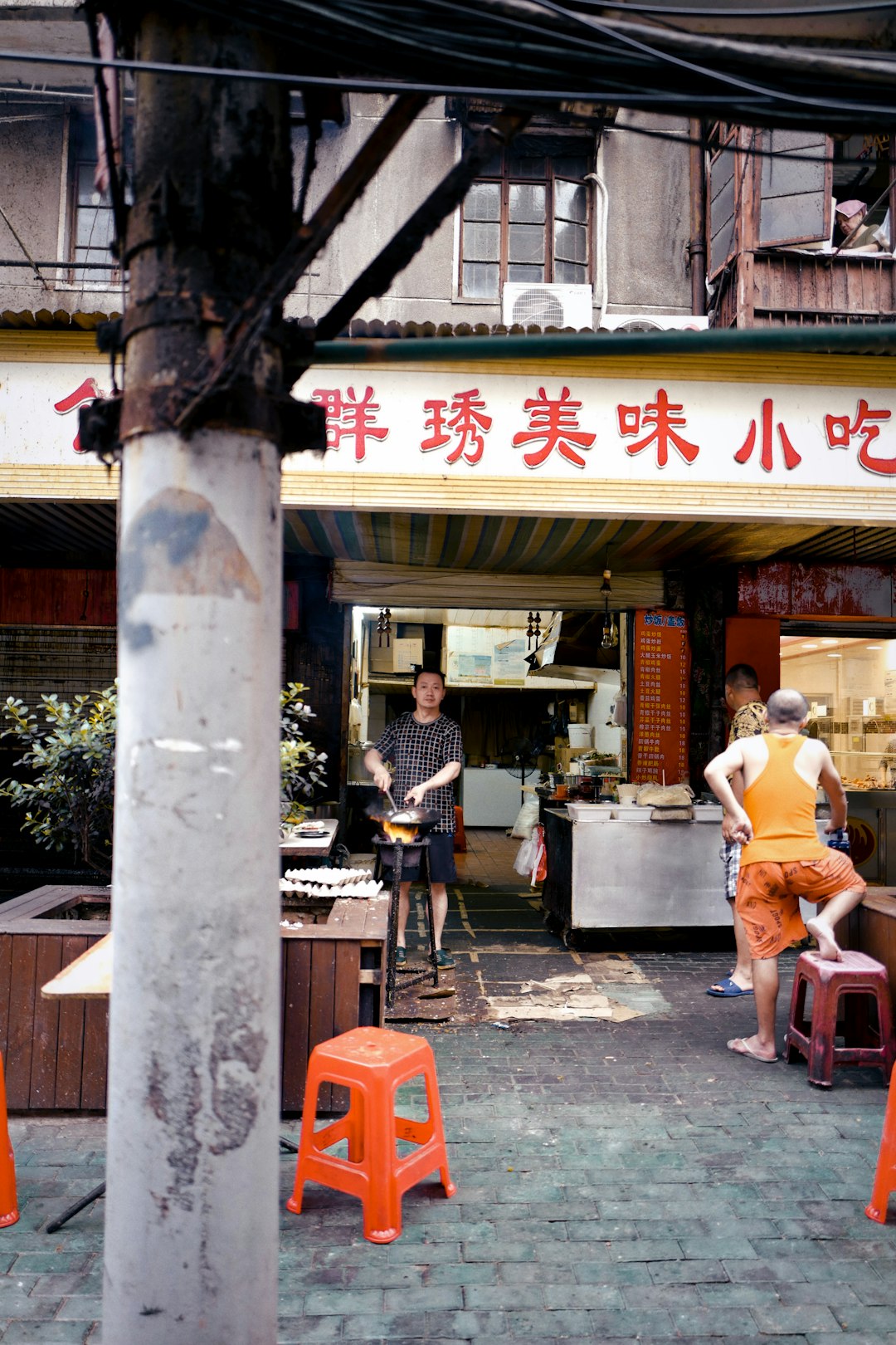 people sitting on chair near store during daytime