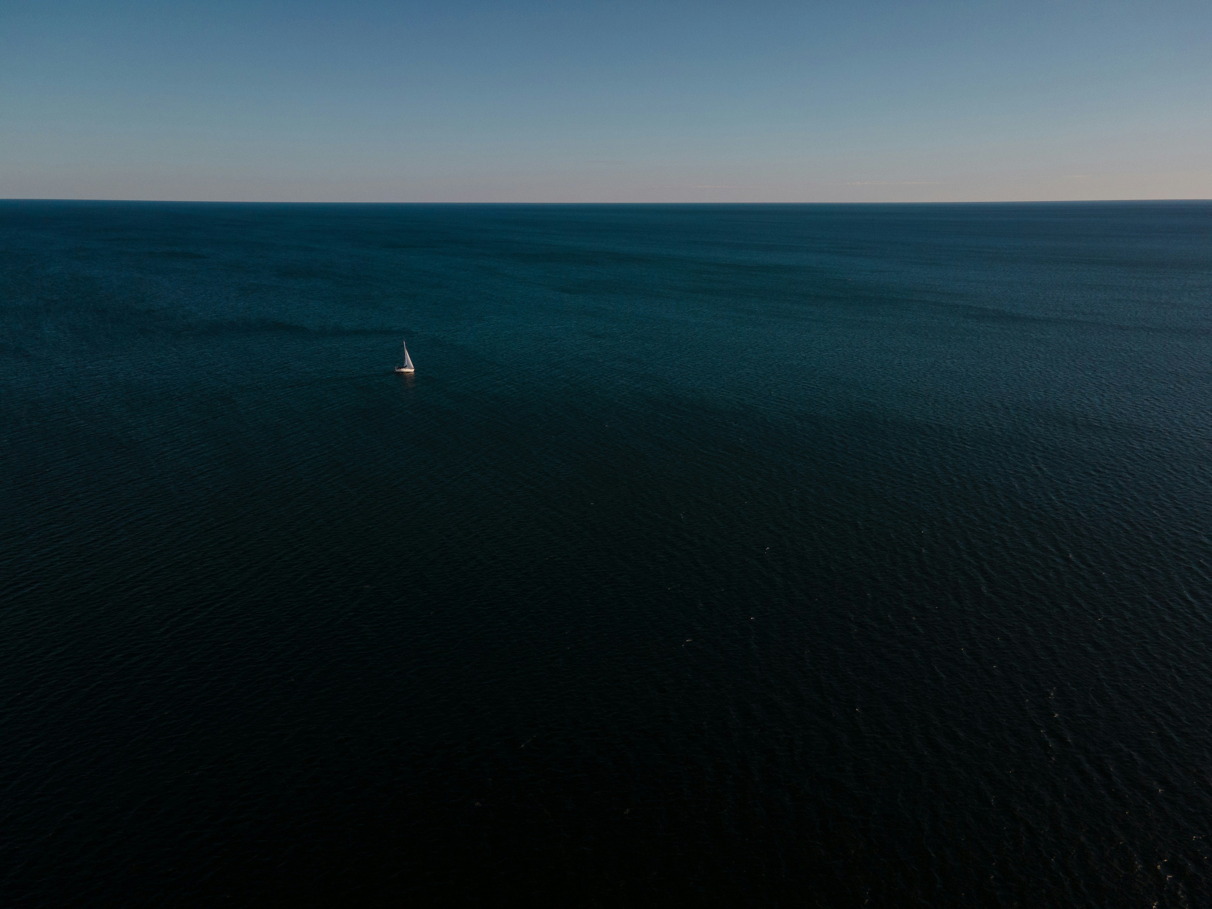 White boat on blue sea under blue sky during daytime photo – Free Sea ...