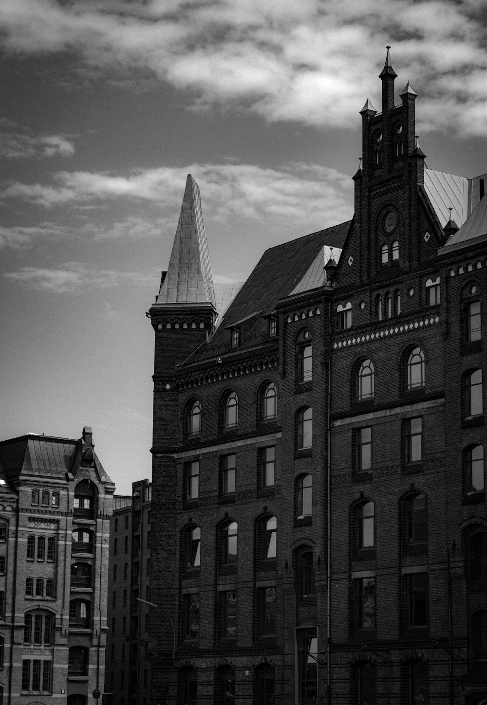 a black and white photo of a building with a clock tower