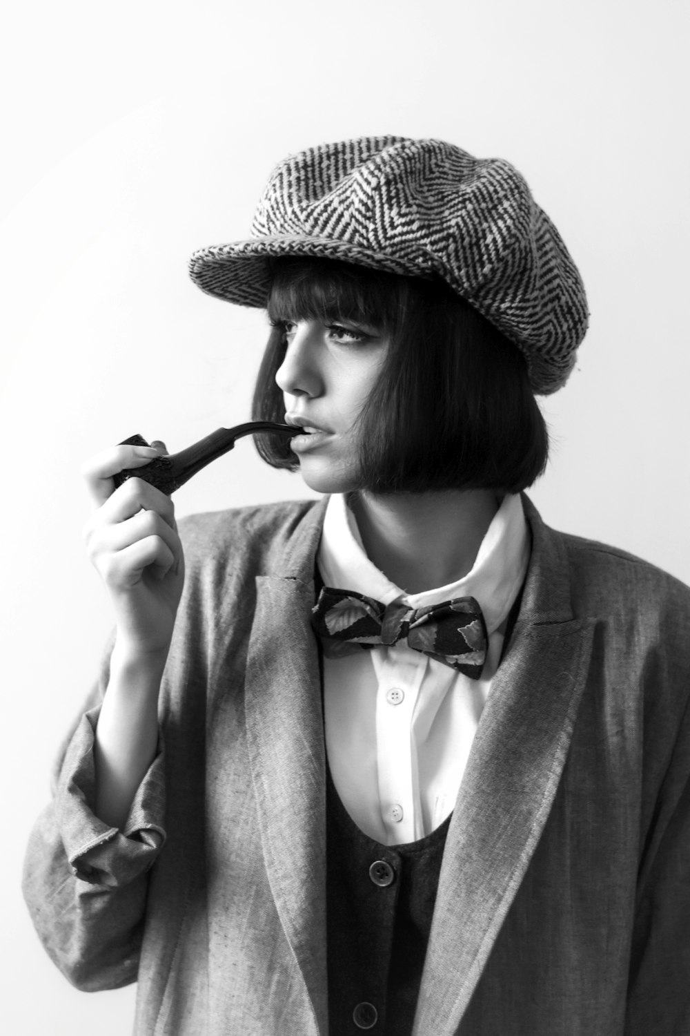 Woman in black and white hat holding black and white stick photo