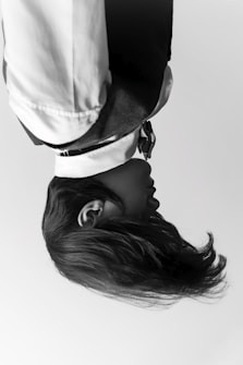 woman in white shirt wearing black hat