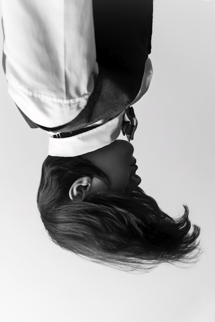 woman in white shirt wearing black hat