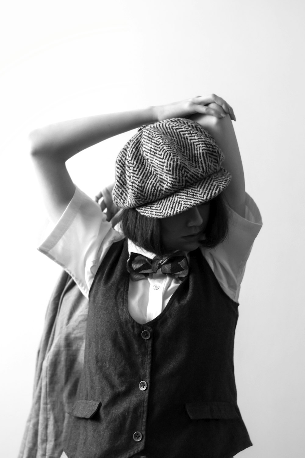 grayscale photo of woman wearing hat and sleeveless dress