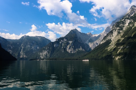 body of water near mountain under blue sky during daytime in Berchtesgaden National Park Germany