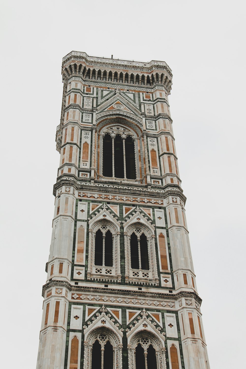 brown concrete tower under white sky during daytime