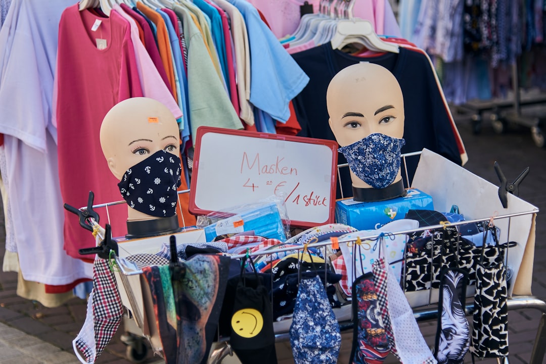 white mask beside pink and white shirts