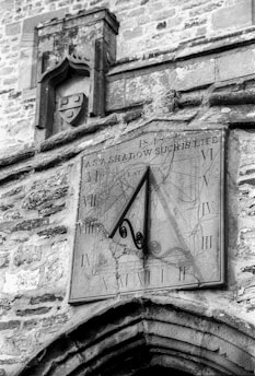 a sundial clock on a wall