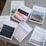 Seven books are arranged on a beige table. Each book cover features a unique landscape photograph and has titles like Psalms, Romans, Ecclesiastes, Genesis, Revelation, Isaiah, and Proverbs.