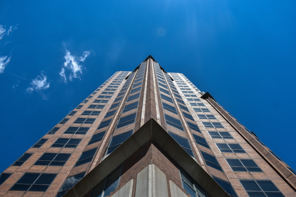 low angle photography of high rise building under blue sky during daytime