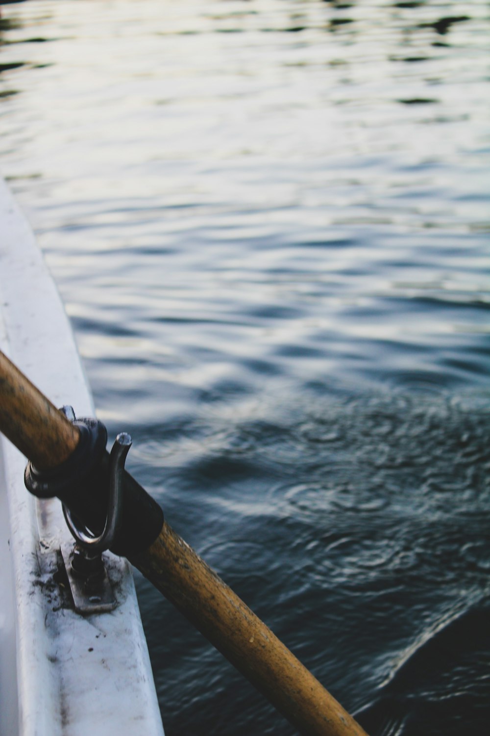 brown wooden stick on body of water during daytime