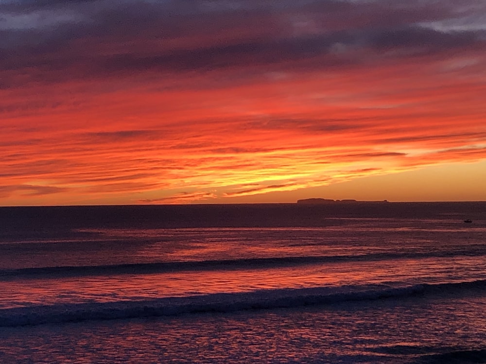 body of water during sunset