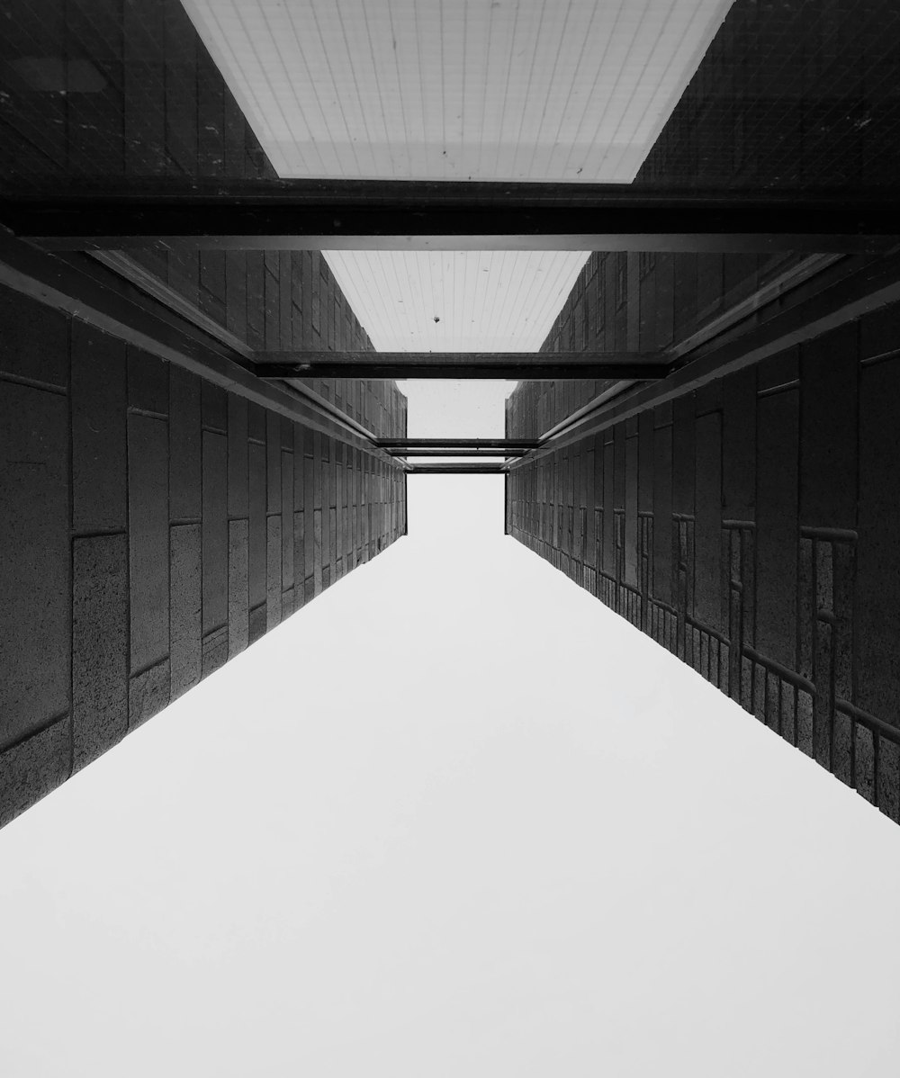 grayscale photo of empty tunnel