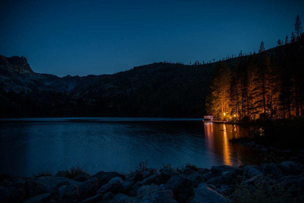 Quai en bois brun sur le lac bleu pendant la nuit