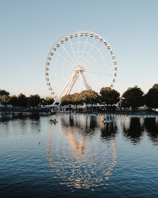 ferris wheel near body of water during daytime in Old Montreal Canada