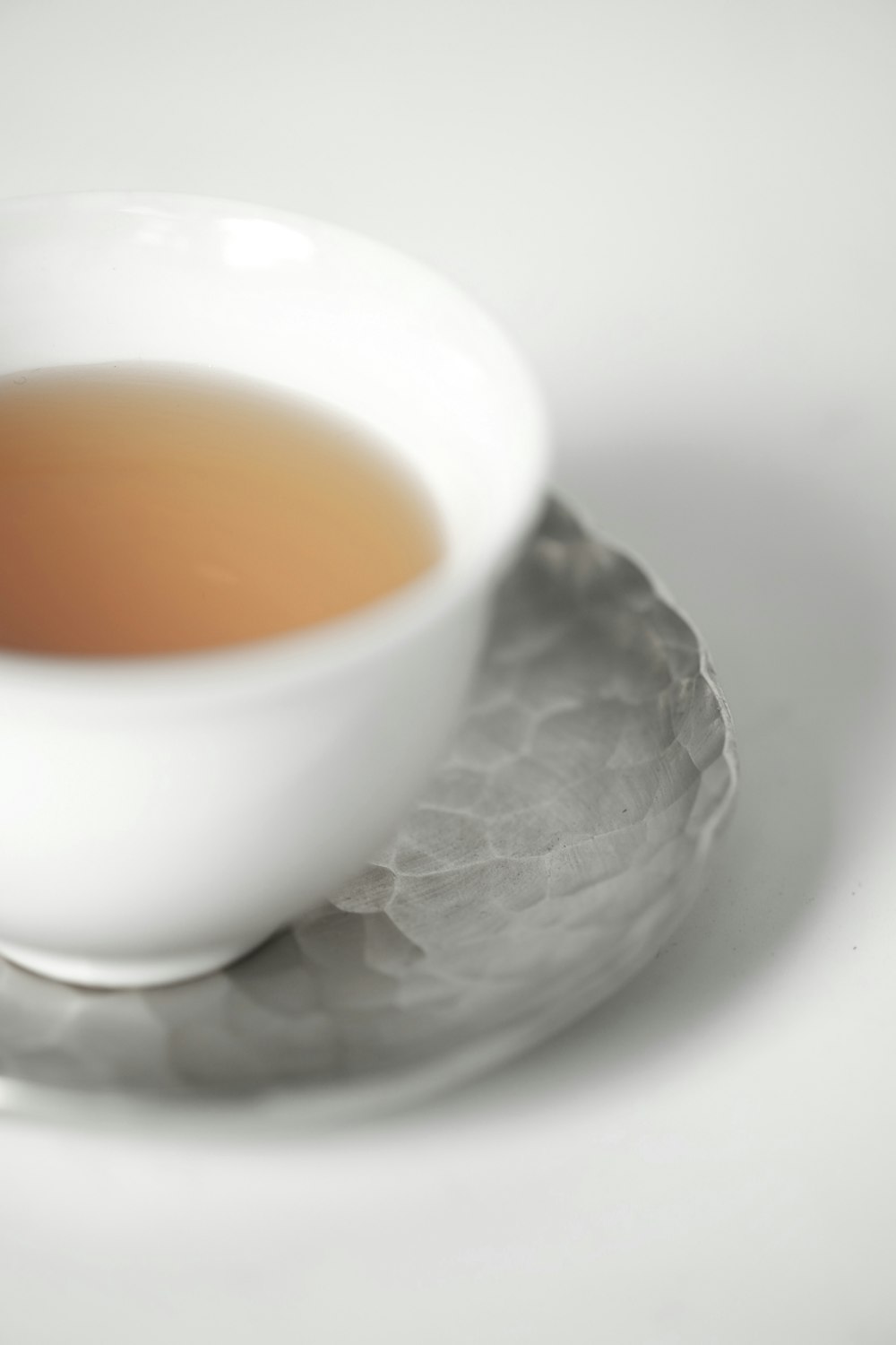 white ceramic cup with brown liquid