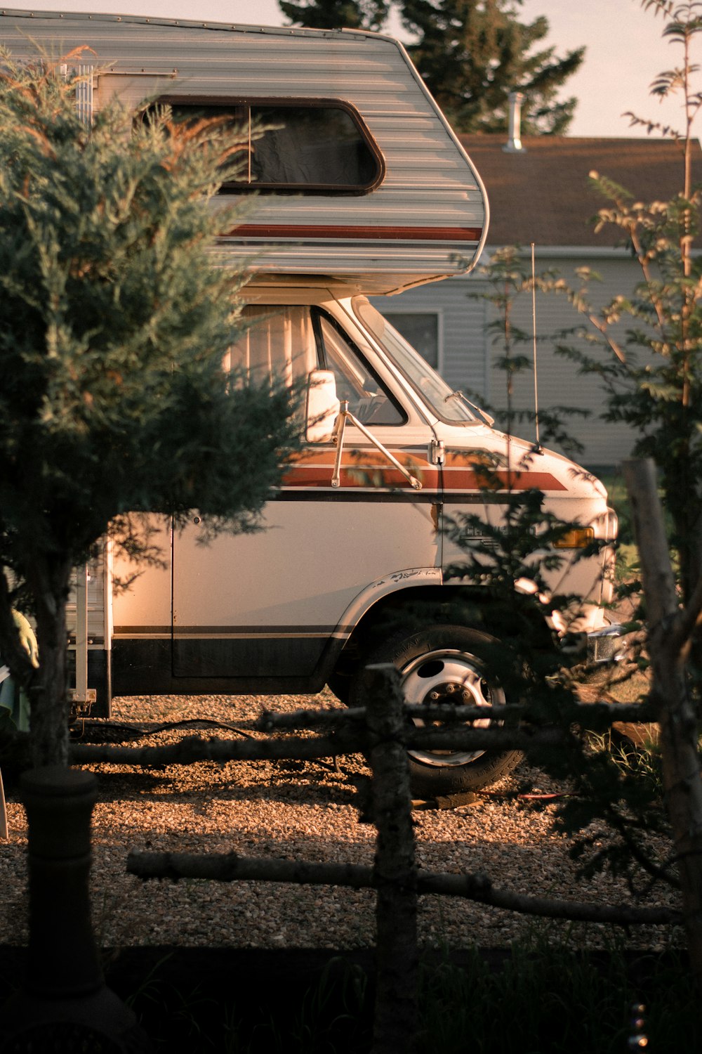 white and brown van near green tree during daytime