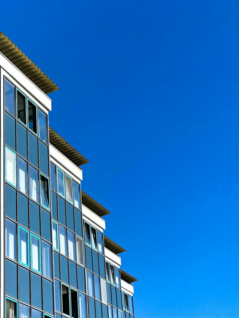 white and blue concrete building under blue sky during daytime