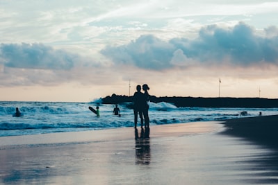 man in black shirt and pants standing on seashore during daytime zihuatanejo teams background