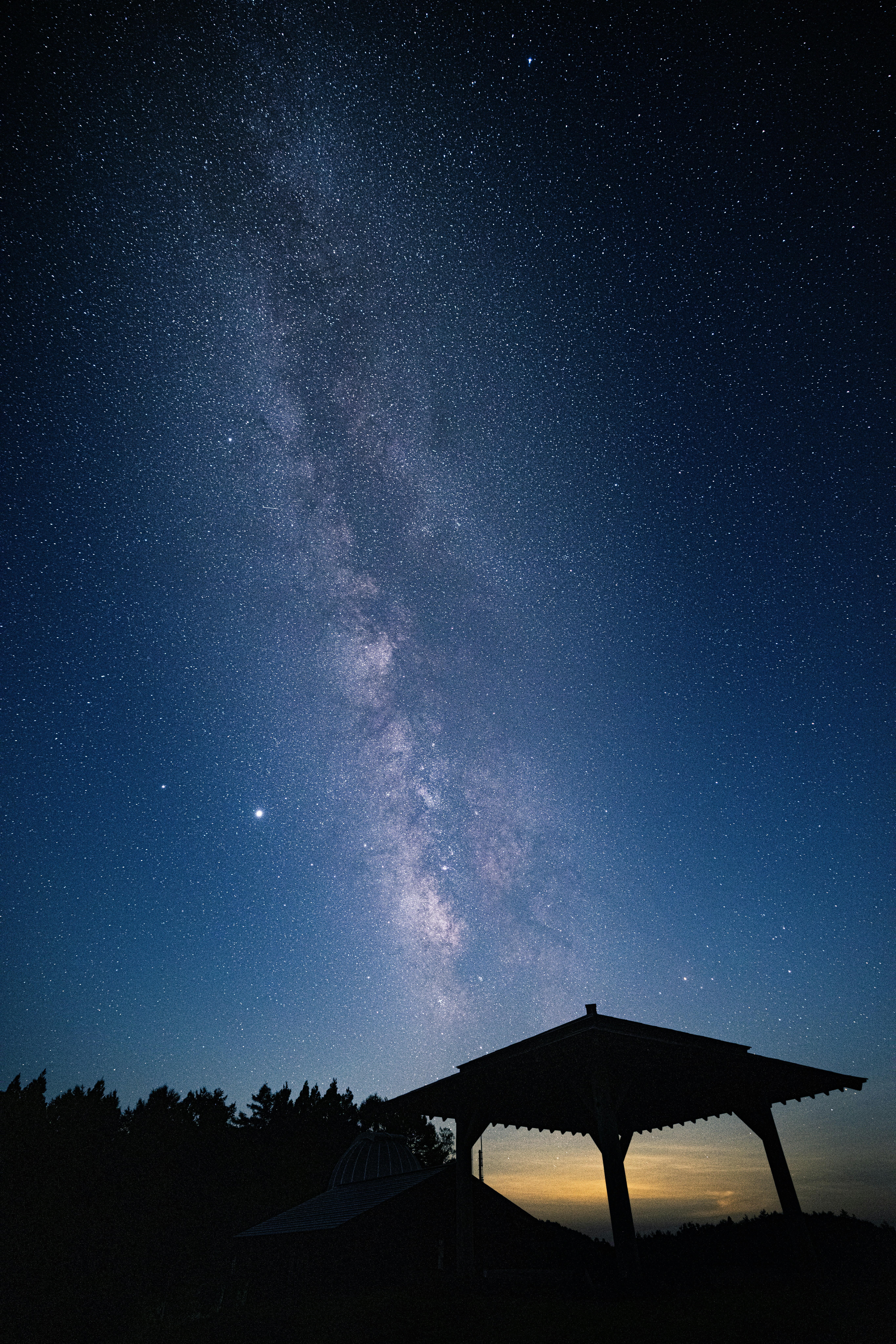 silhouette of house under starry night