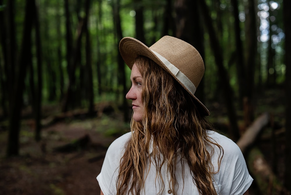 woman in white long sleeve shirt wearing brown fedora hat