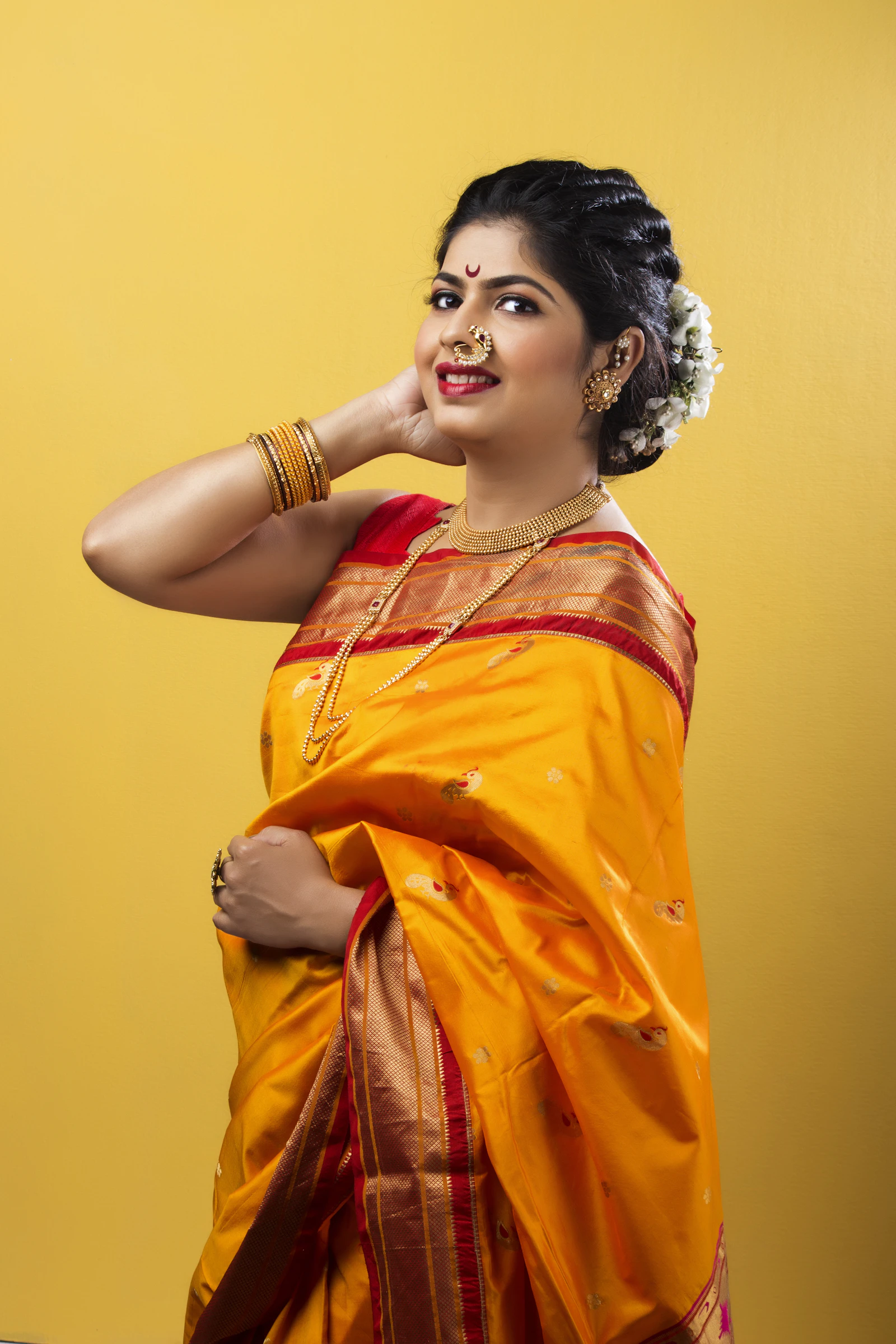A woman in a golden tussar silk saree