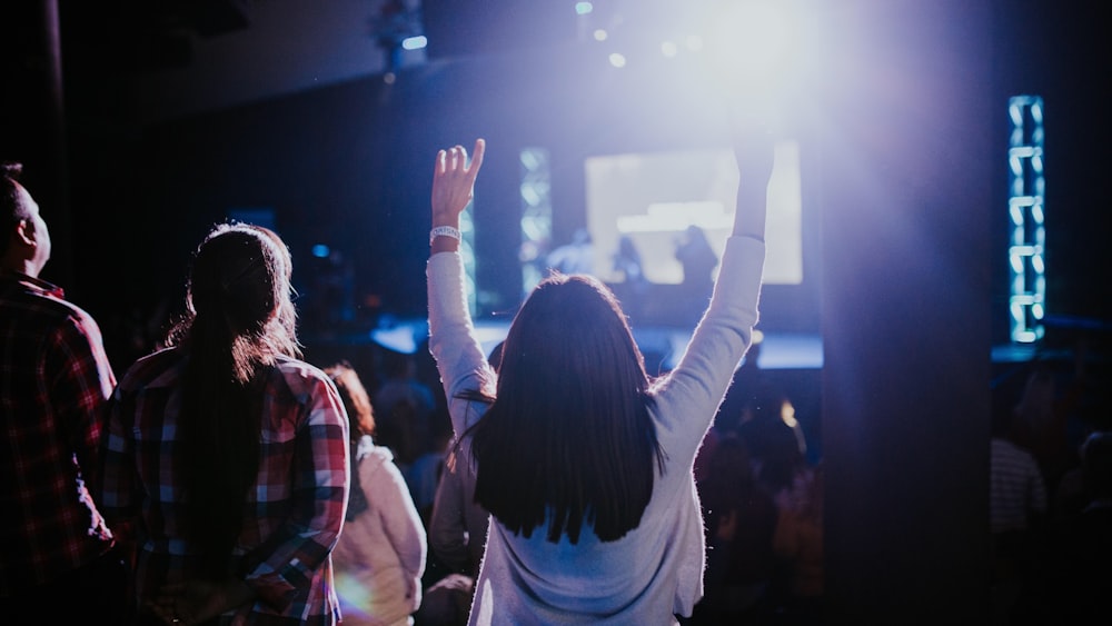 people standing on stage with lights