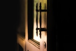 A moody, shadowy photograph of a closed front door at dusk representing mystery and tension.