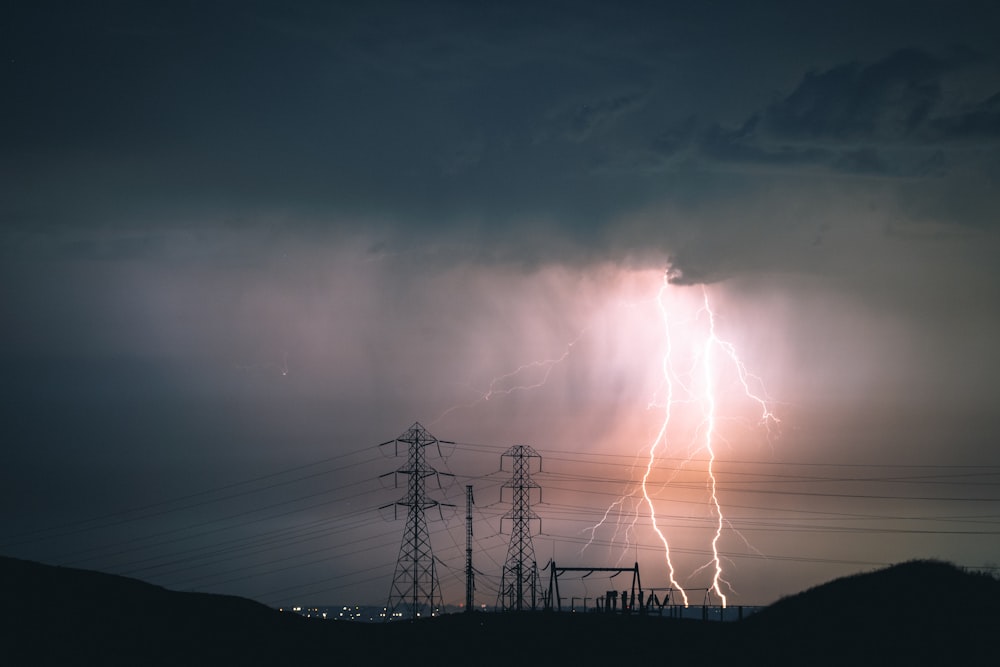 silhouette of electric tower during sunset