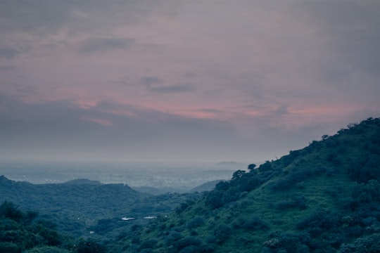 green mountains under white clouds during daytime in Gandhinagar India