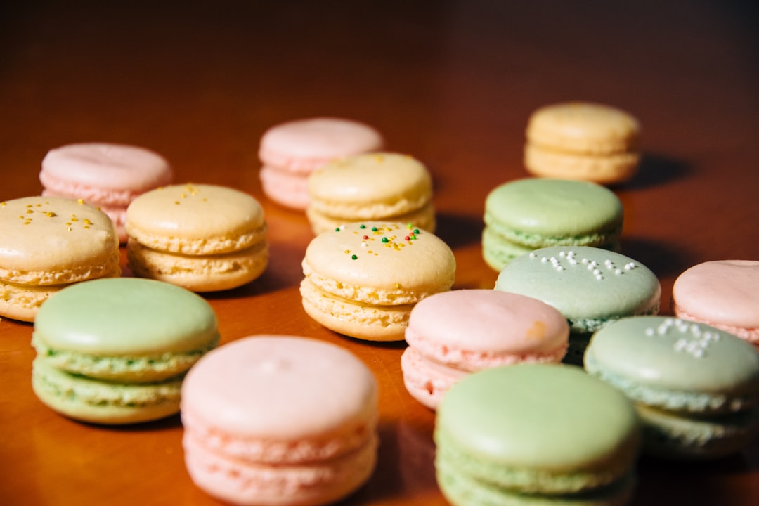 white and brown cookies on brown wooden table,