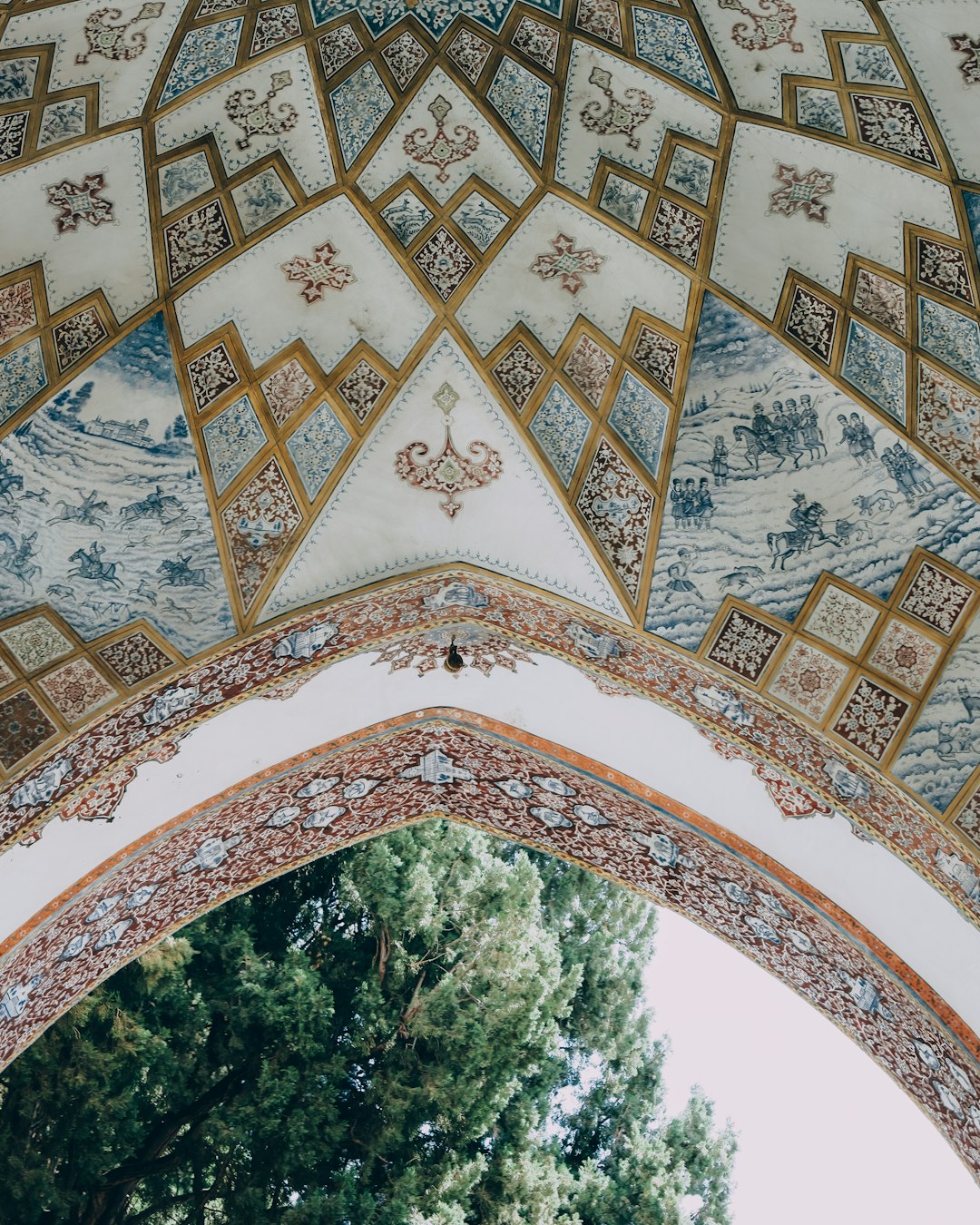 green trees under white and brown floral arch