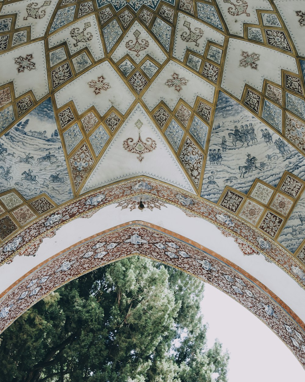 green trees under white and brown floral arch