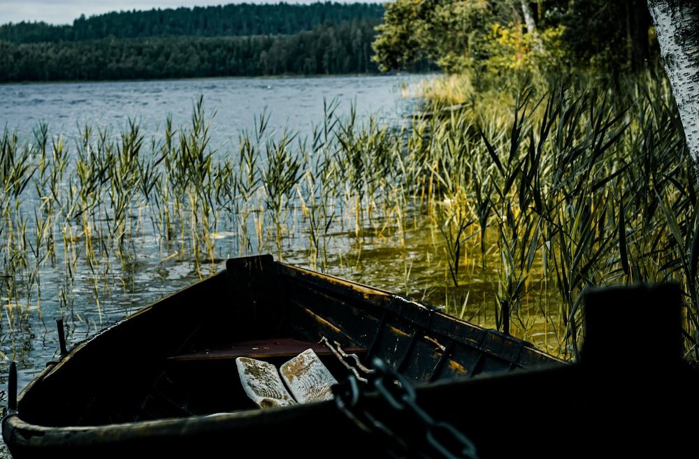 brown wooden boat on lake during daytime