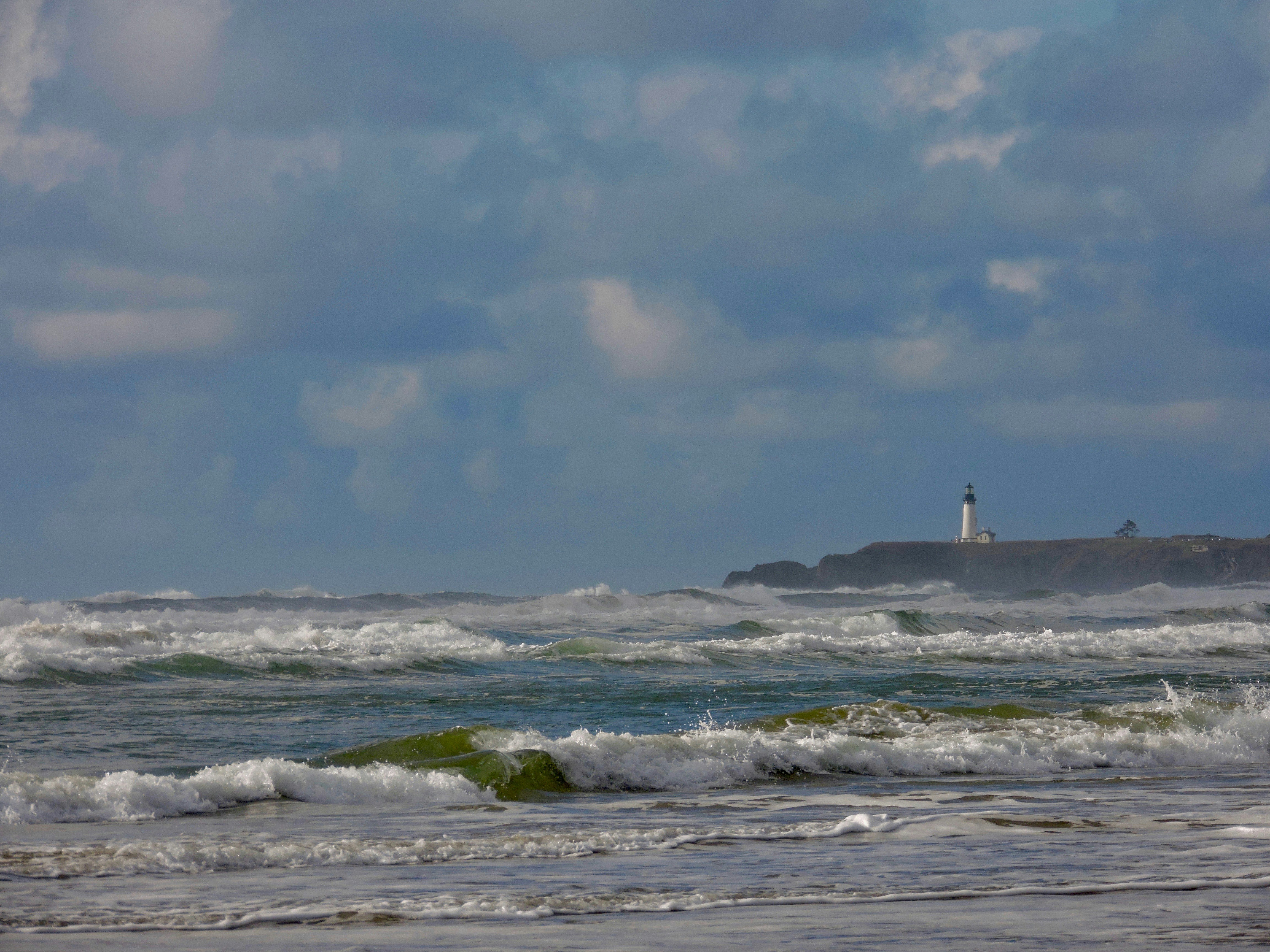 Video thumbnail: A lighthouse on a stormy cliff, waves crashing violently, dramatic clouds rollin