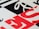 Geometric pattern with bold typography featuring overlapping black, white, and red letters. The design includes diagonal and horizontal lines creating a modern and abstract visual.