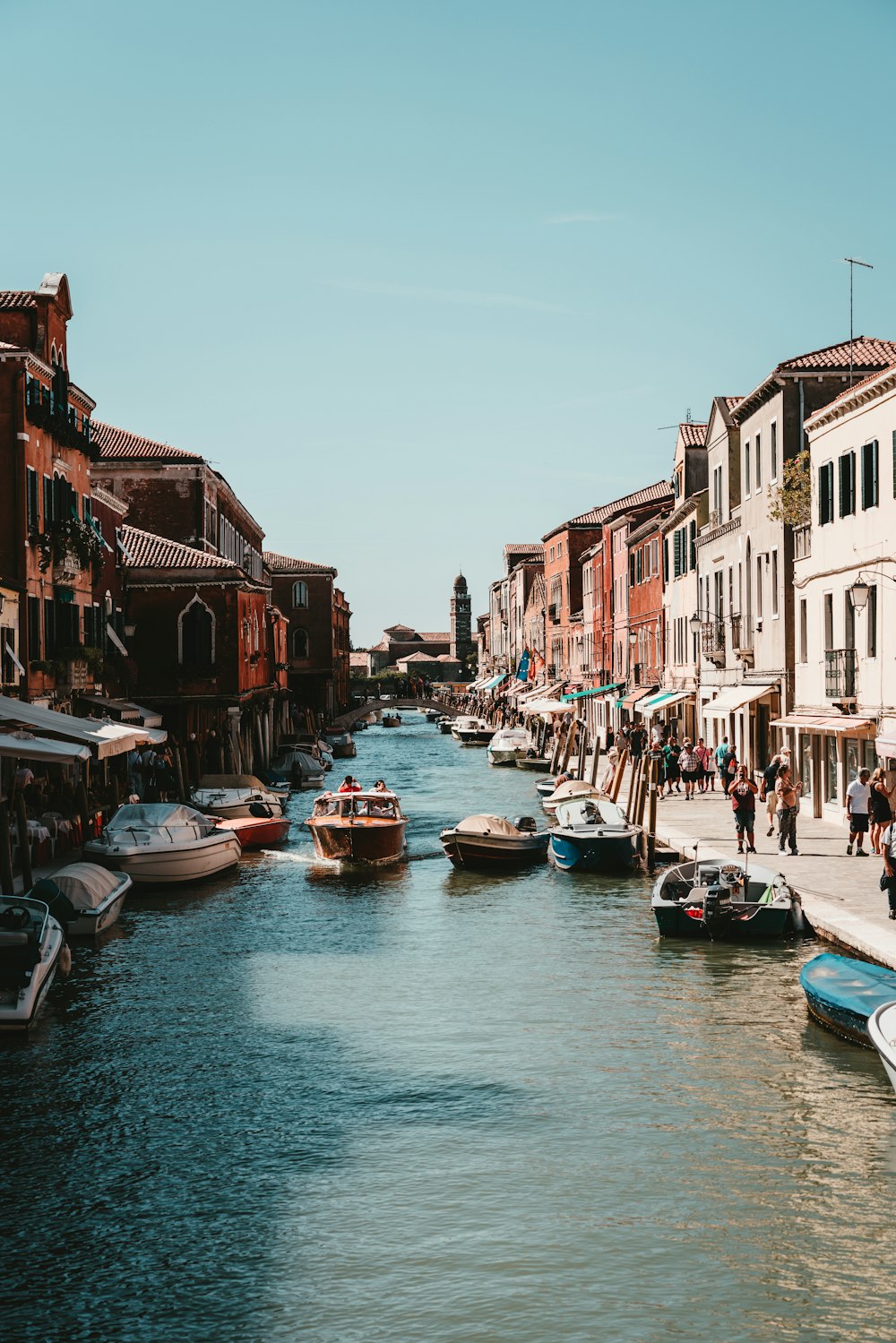 boat on river between buildings during daytime