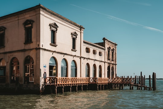 white concrete building beside body of water during daytime in Murano Italy