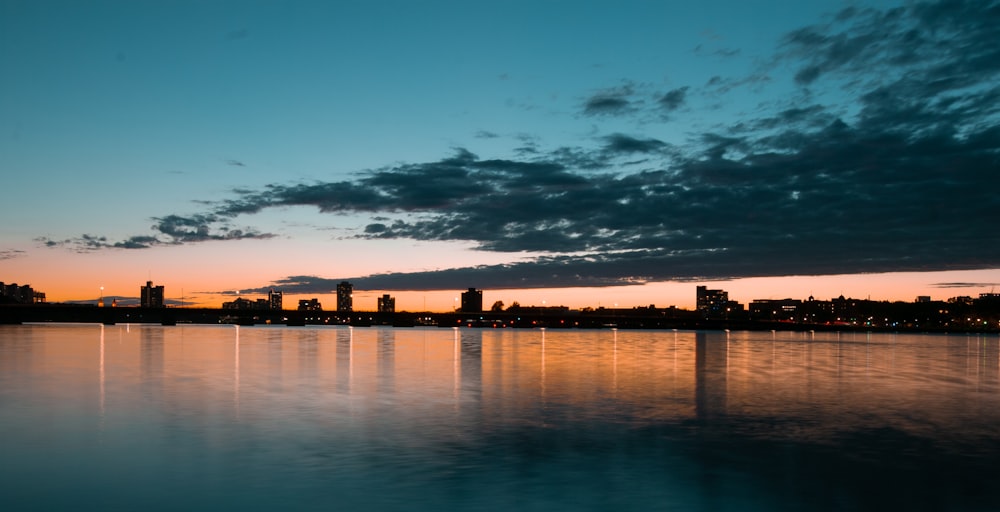 silhouette of city skyline during night time