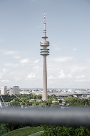A completed telecom tower standing tall against a clear blue sky, surrounded by cityscape.