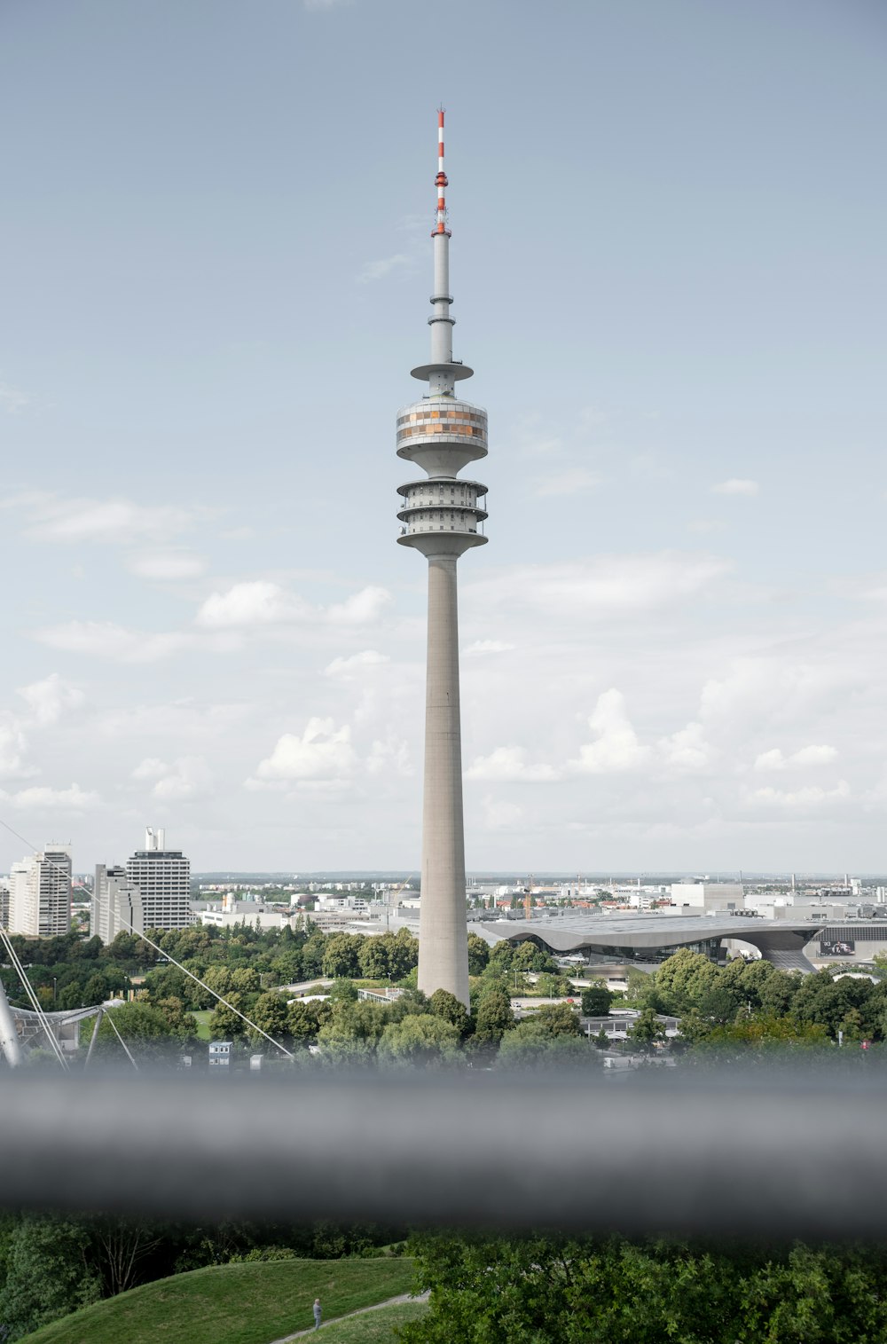 white and brown tower near city buildings during daytime