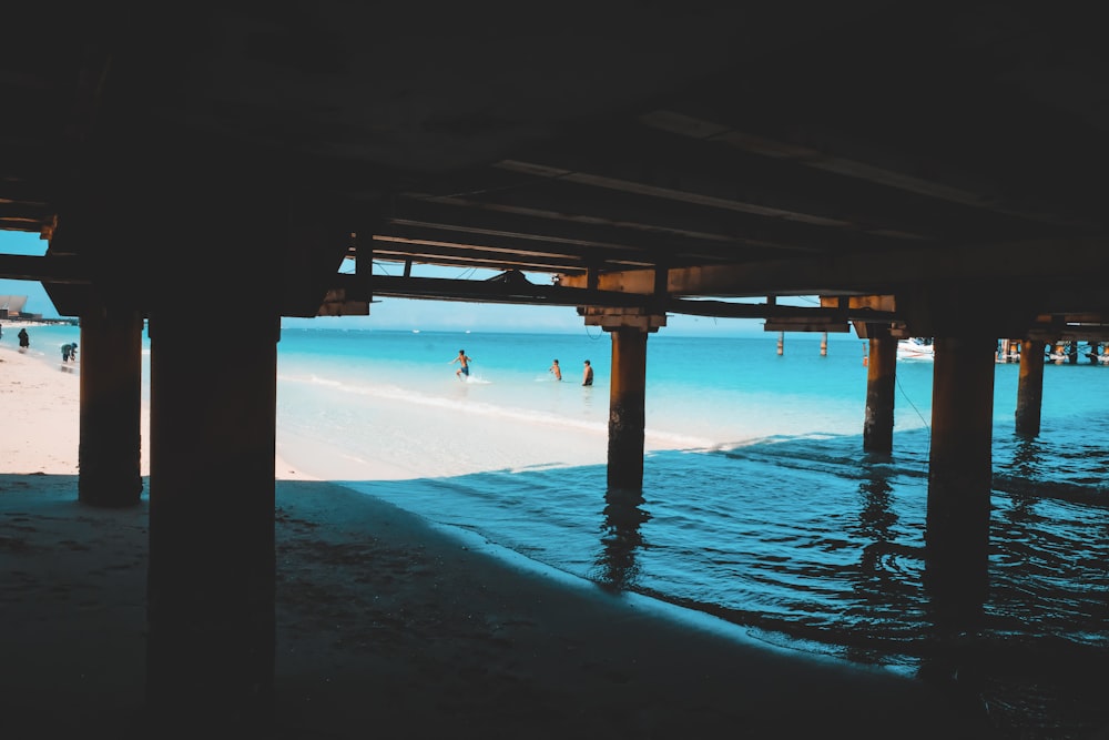 brown wooden dock on blue sea during daytime