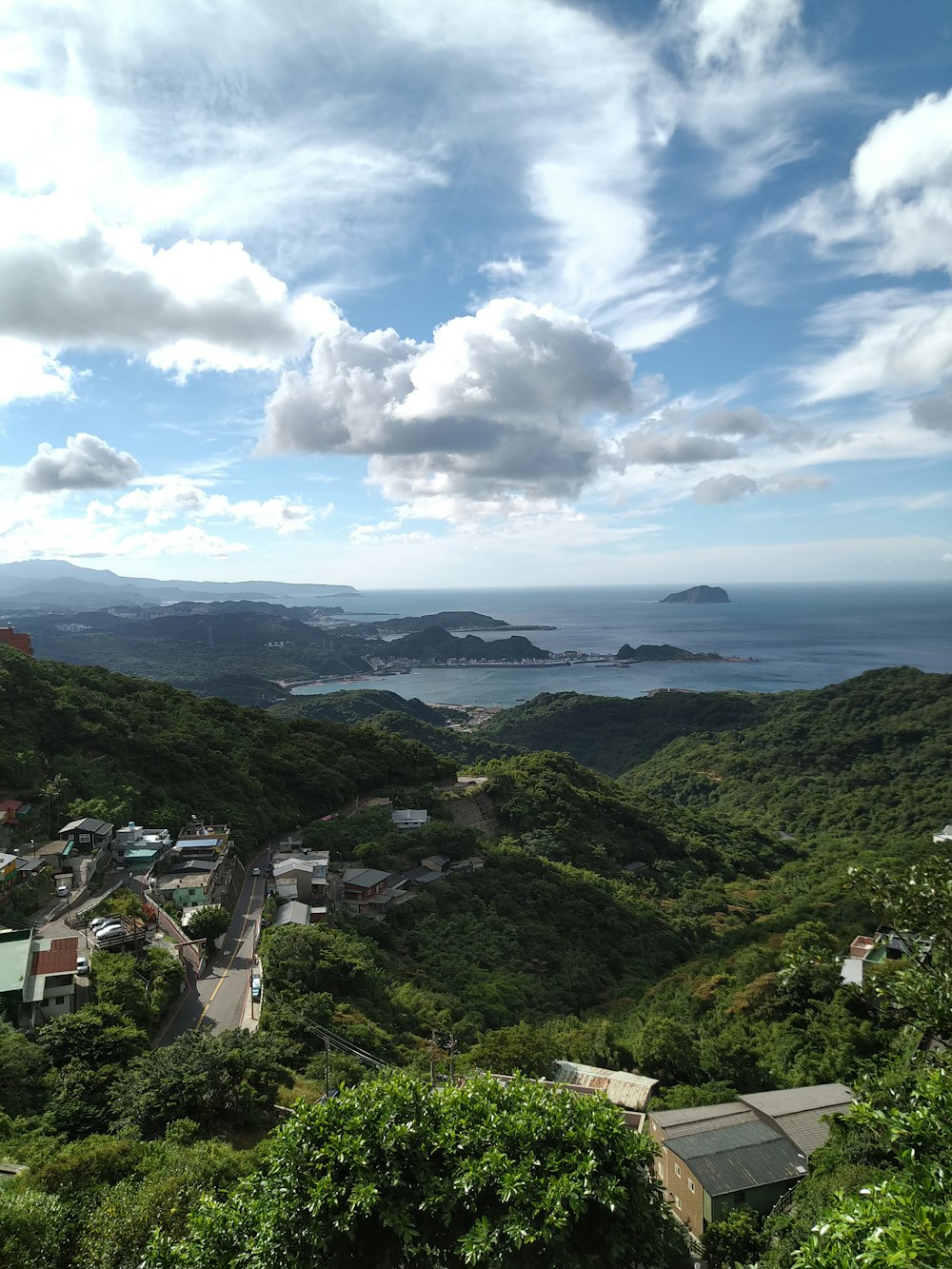 a scenic view of a town and a body of water