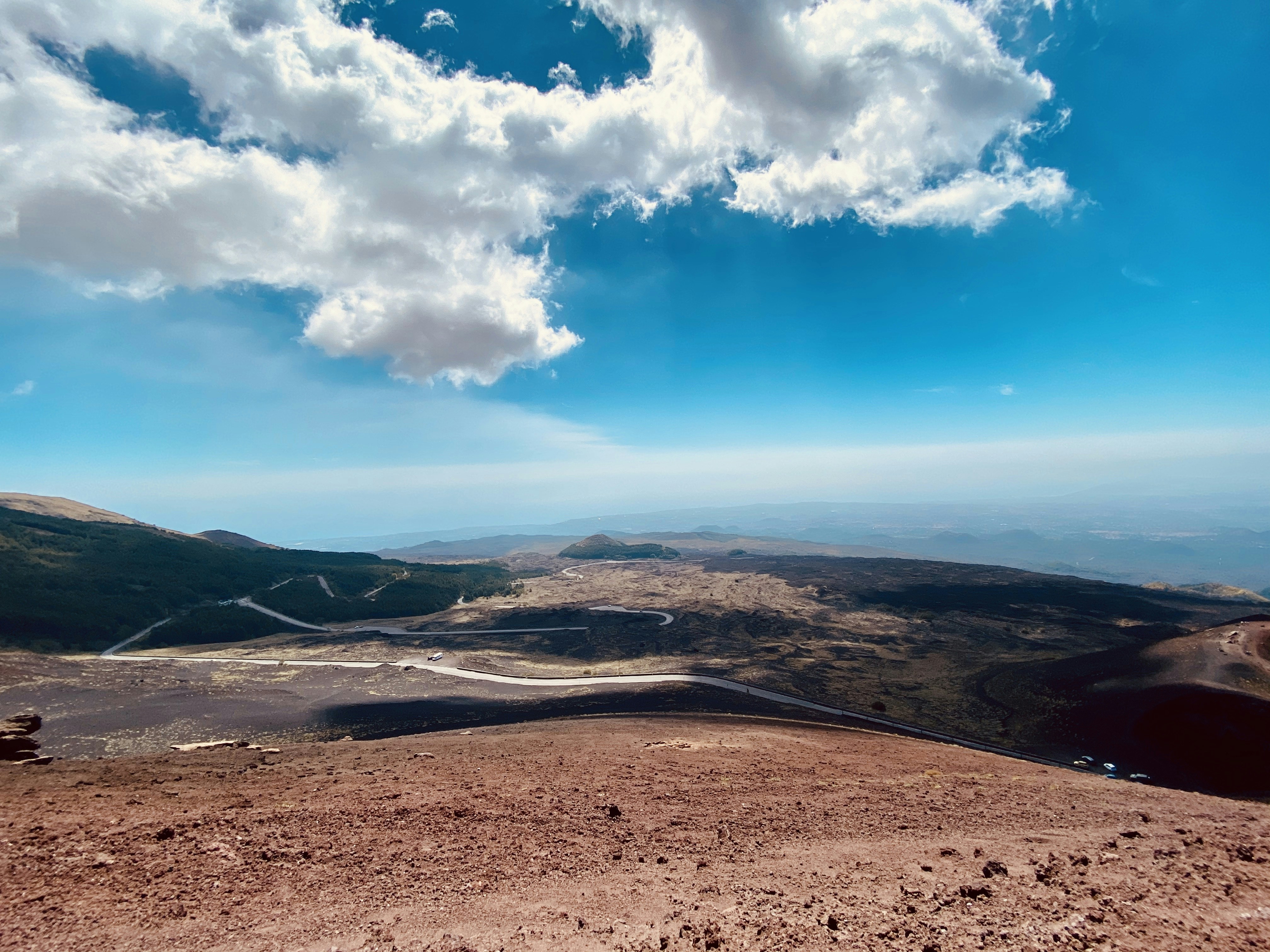 a scenic view of a mountain range with clouds in the sky