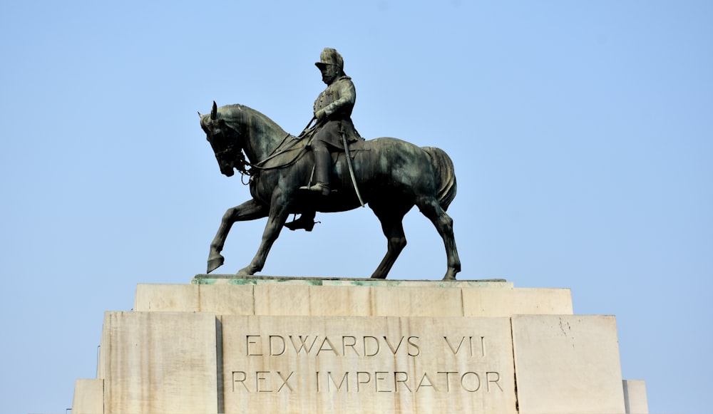 man riding horse statue during daytime