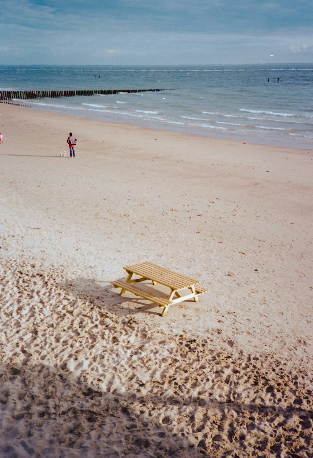 brown wooden lounge chair on beach during daytime
