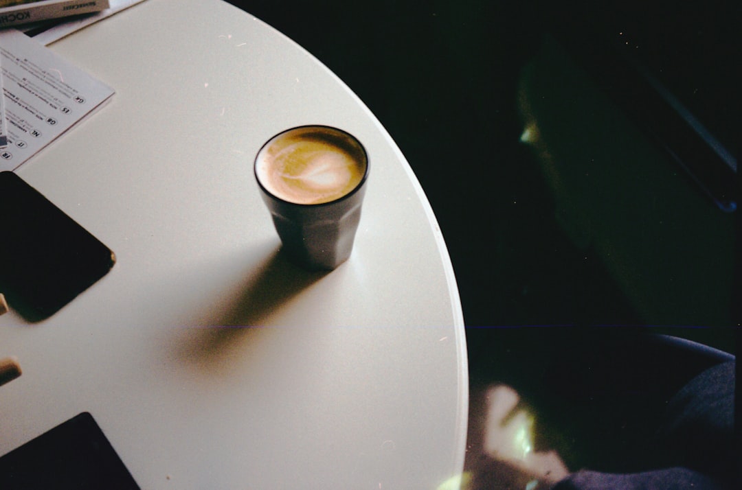 white ceramic mug on white table