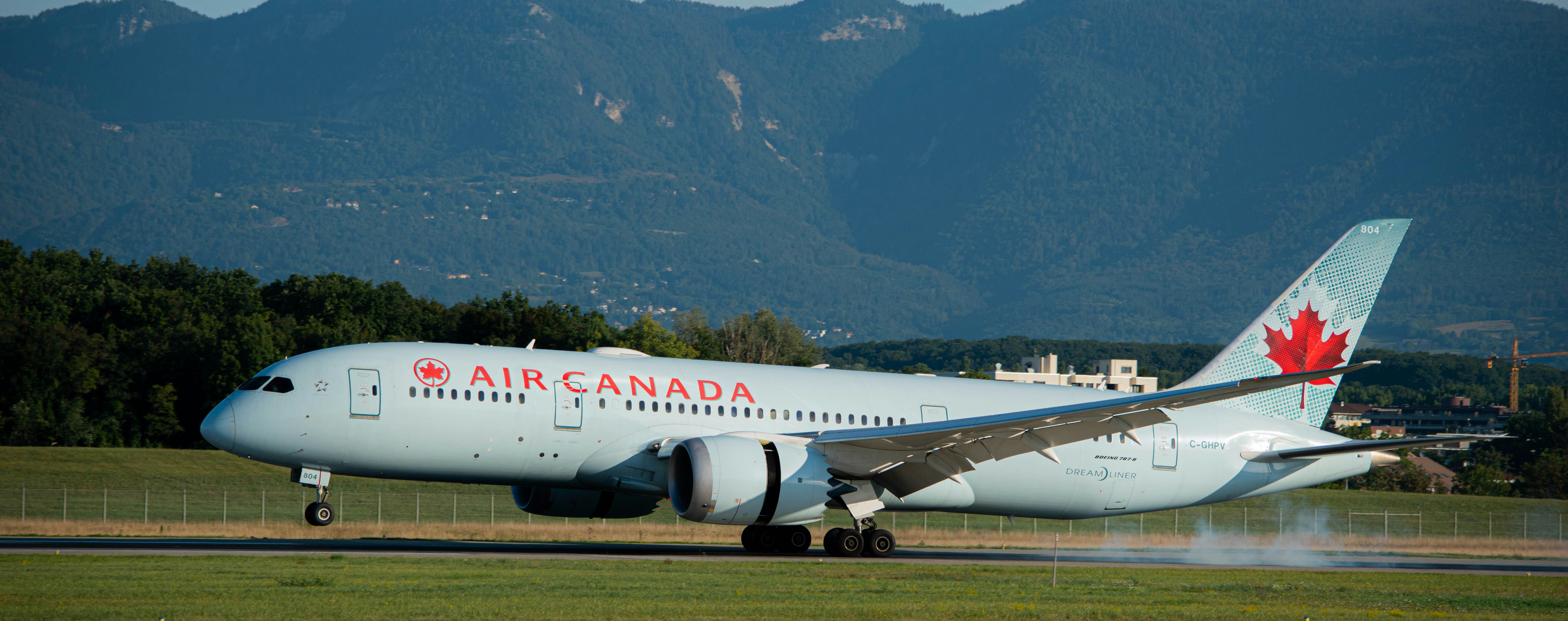 white passenger plane on green grass field during daytime