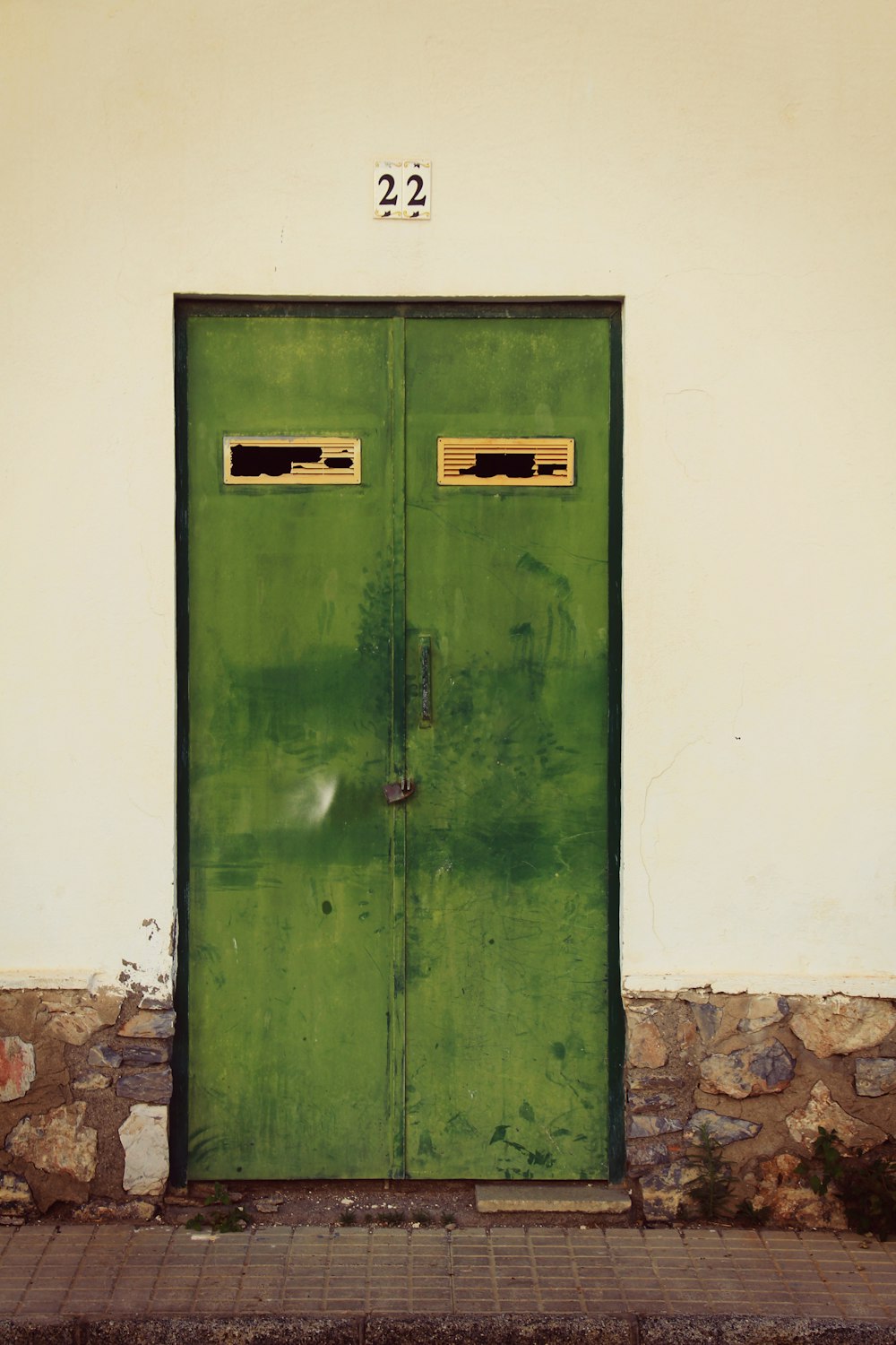 green wooden door on white painted wall