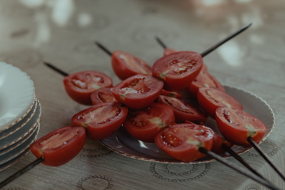 red sliced tomatoes on stainless steel round plate