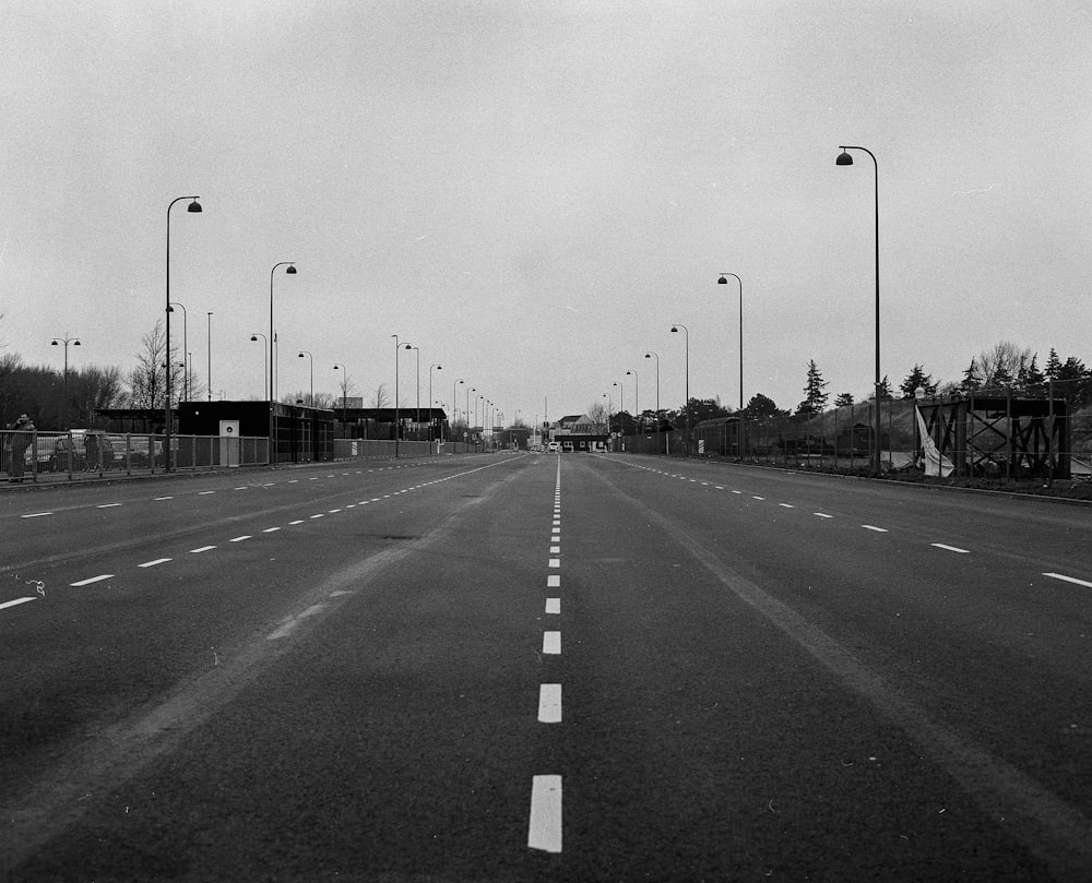 grayscale photo of road with cars